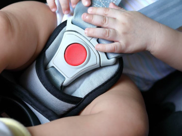 Baby buckled into car seat