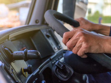 Trucker driver holding steering wheel