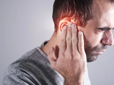 A man holds his head — recognizing brain bleed symptoms could save your life.