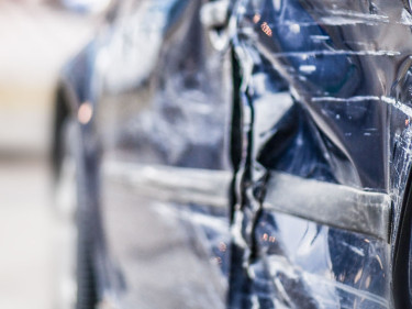 Close-up of severe side panel damage on a vehicle after a car accident, illustrating the property destruction that accompanies serious collision injury claims