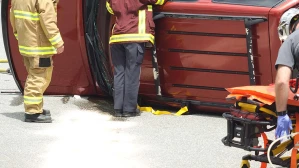 Emergency responders work around an overturned SUV at the scene of a serious crash, highlighting the reality of deaths from road accidents.