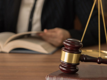 A Houston car accident attorney researches the law and talks to a colleague.