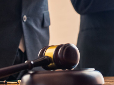 Houston car accident lawyers shake hands with a client after winning a case.