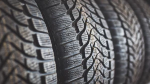 Close-up of vehicle tire tread pattern on storage rack relevant to defective tire blowout liability litigation