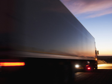Speeding tractor trailer at dawn