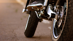 Close-up of motorcycle wheels and rider