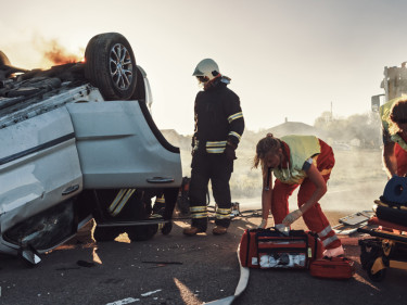 Roll over car accident with paramedics at the scene