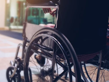 Person in wheelchair navigating an urban ramp representing long-term disability after personal injury