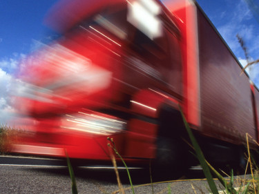 Speeding red tractor trailer