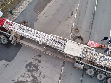 Aerial view of jackknifed commercial truck with oversized load blocking intersection after crash