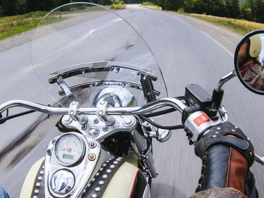 A motorcycle rider traveling down the road, hoping to avoid motorcycle accidents in Texas.