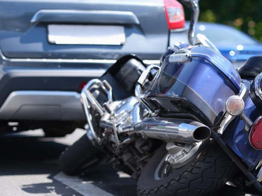A motorcycle collision is shown, a situation where consulting a motorcycle wreck attorney is highly advisable.