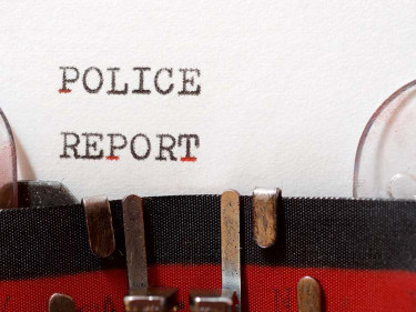 Close-up of the words Police Report typed on paper in a vintage typewriter, representing the official documentation used to support car accident injury claims