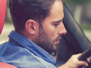 A reckless driver is seen texting behind the wheel.
