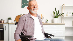 Senior man in a wheelchair after suffering spinal cord injuries