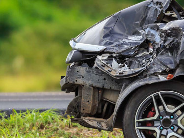 A black car with a damaged front from a Texas car crash.