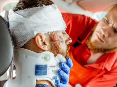 An injured man gets assessed following a Texas truck collision.
