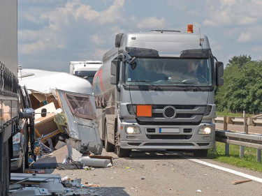 Tanker truck involved in multi-vehicle highway accident with debris scattered across road