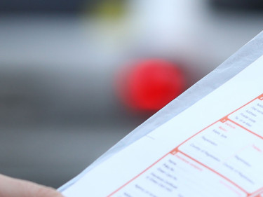 Man fills out a vehicle accident report