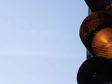 A yellow traffic light like this one requires drivers to know the answer to “What does yield mean in driving?”