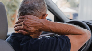 Man suffering neck injury following whiplash during car accident