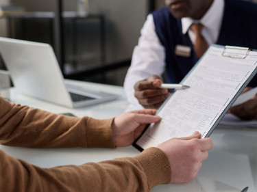 An employee who suffered a workplace injury works with a lawyer on their legal claim.